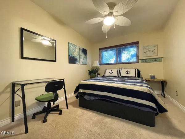 a bedroom with bed and a ceiling fan