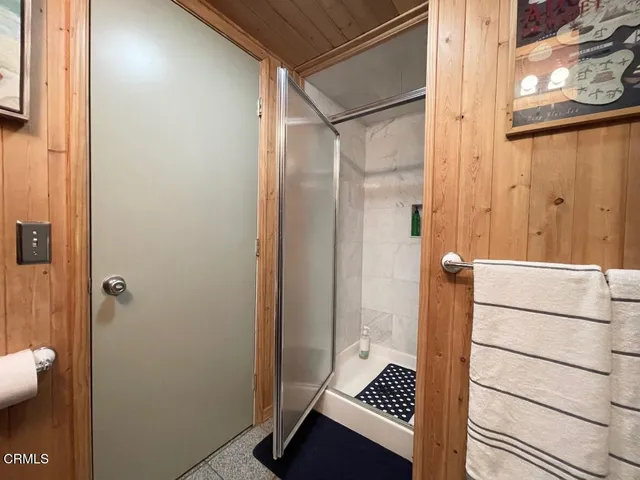 a bathroom with a shower and a sink
