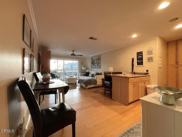 a living room with furniture a dining table and kitchen view