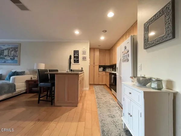 a kitchen with stainless steel appliances kitchen island granite countertop a sink and cabinets
