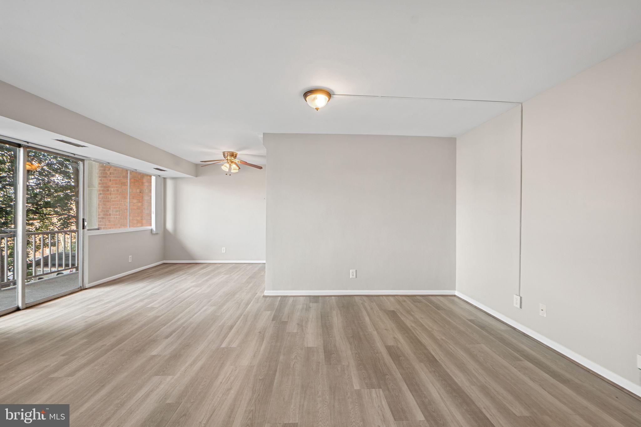431 North Armistead Street, Unit 211 Alexandria, VA 22312 - Photo 13 of 27 an empty room with wooden floor and windows