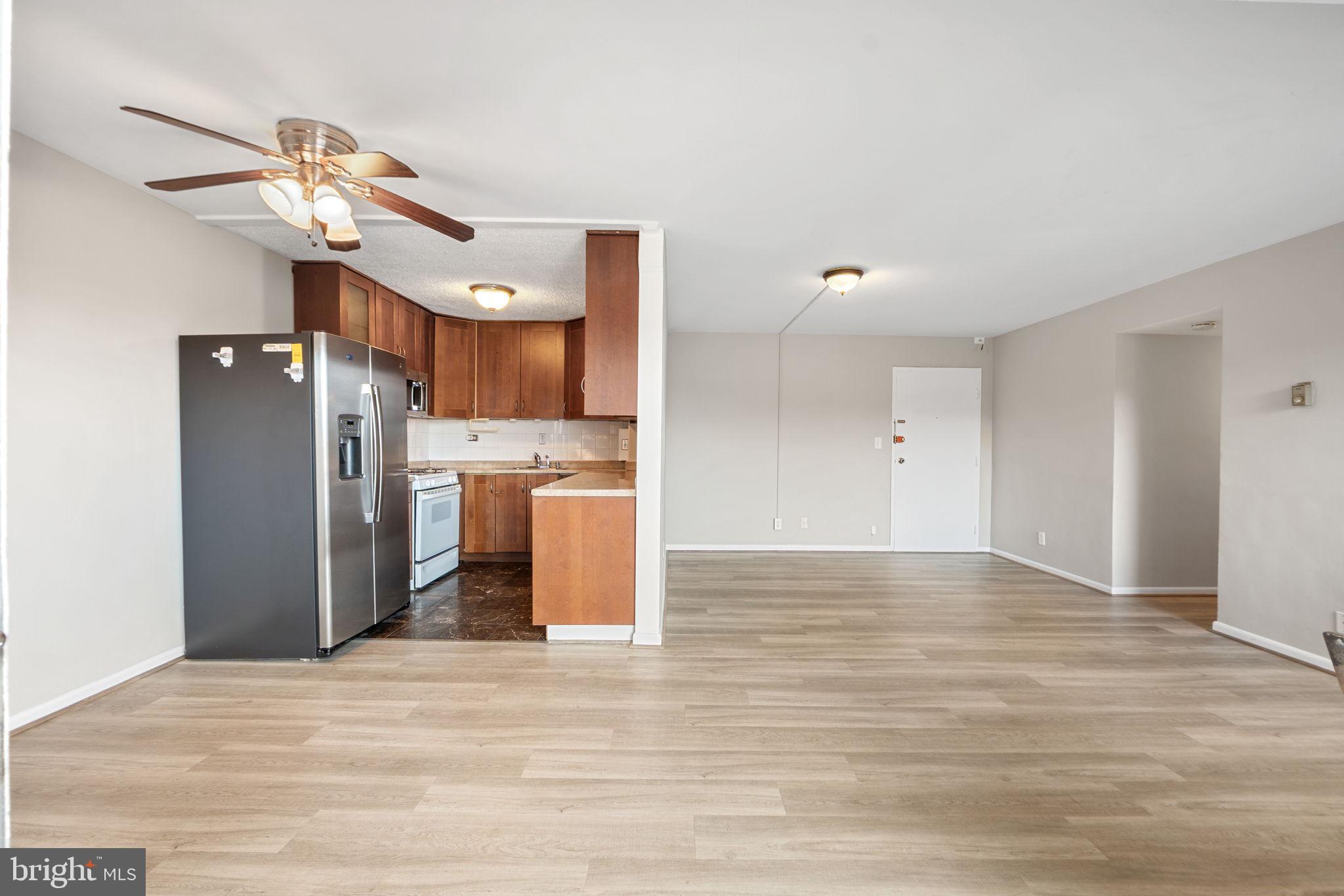 431 North Armistead Street, Unit 211 Alexandria, VA 22312 - Photo 15 of 27 a view of a kitchen with a refrigerator and a chandelier