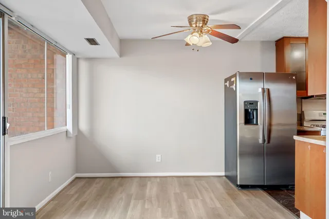 a view of a refrigerator in kitchen and wooden floor