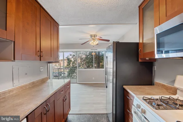 a kitchen with a stove a sink and a refrigerator