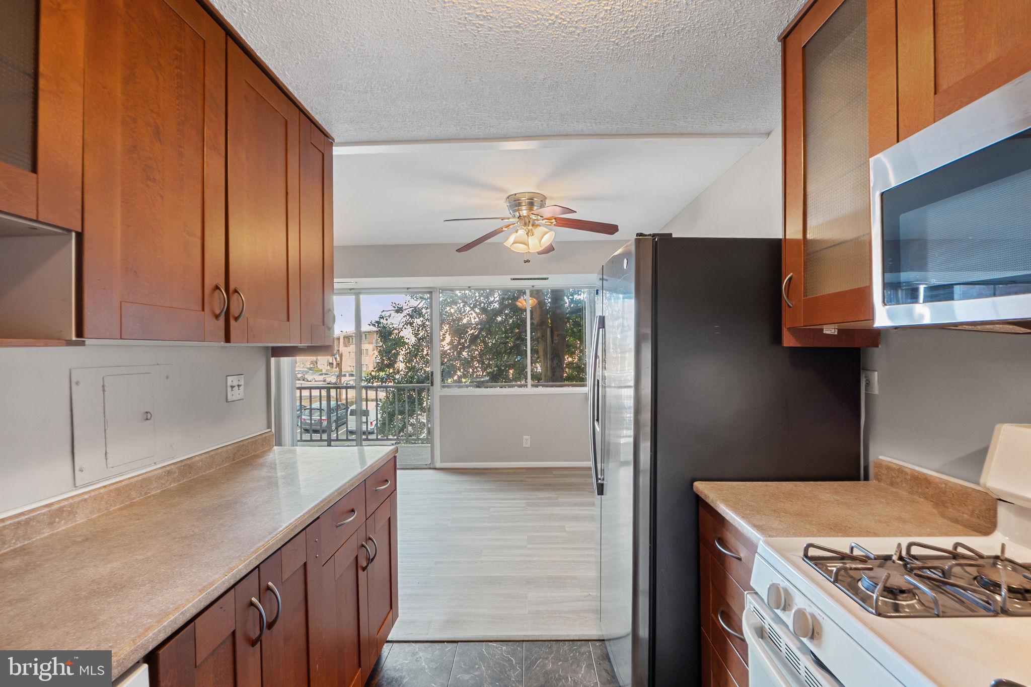 431 North Armistead Street, Unit 211 Alexandria, VA 22312 - Photo 19 of 27 a kitchen with a stove a sink and a refrigerator