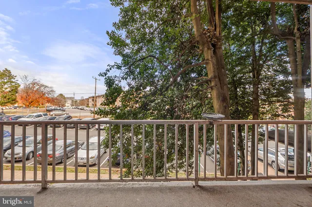 a balcony with trees in front of it