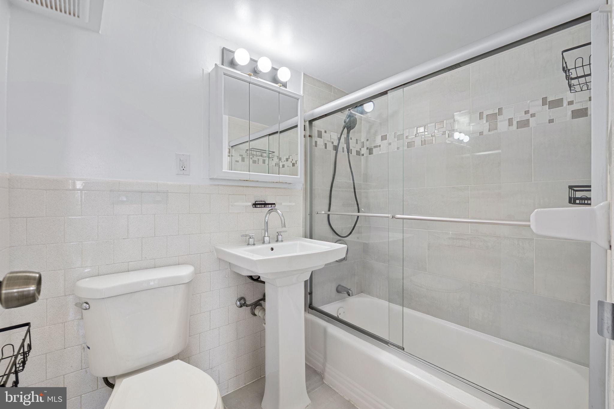 431 North Armistead Street, Unit 211 Alexandria, VA 22312 - Photo 5 of 27 a bathroom with a sink a toilet and shower