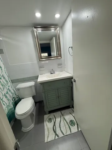 a bathroom with a sink toilet vanity and tub