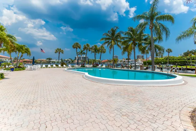 a view of a patio with couches and pool