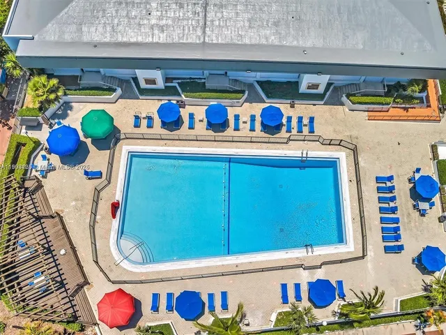 a view of parking garage with cars parked