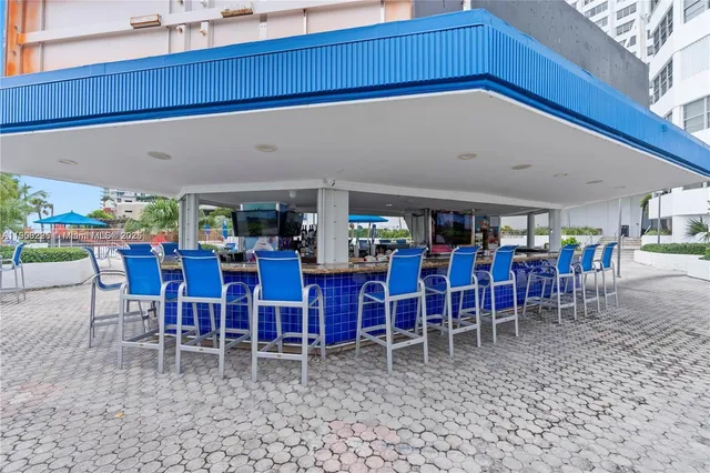 a view of a swimming pool with outdoor seating