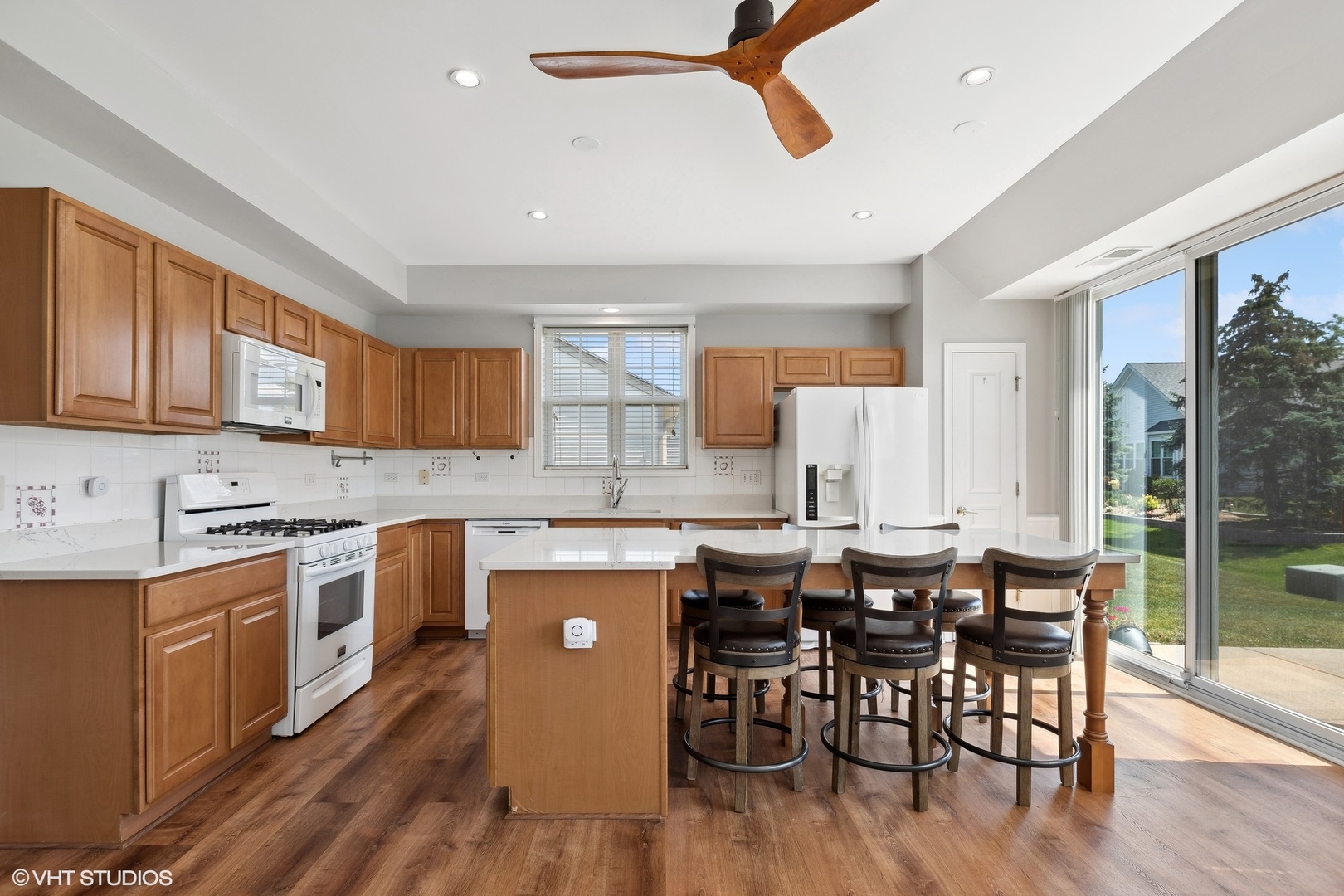 13551 Nealy Road Huntley, IL 60142 - Photo 2 of 15 a kitchen with stainless steel appliances a dining table chairs stove and white cabinets