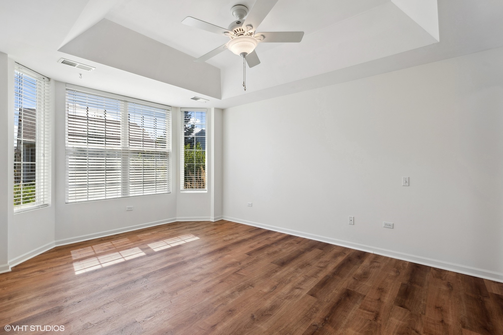 13551 Nealy Road Huntley, IL 60142 - Photo 6 of 15 a view of an empty room with a window and wooden floor