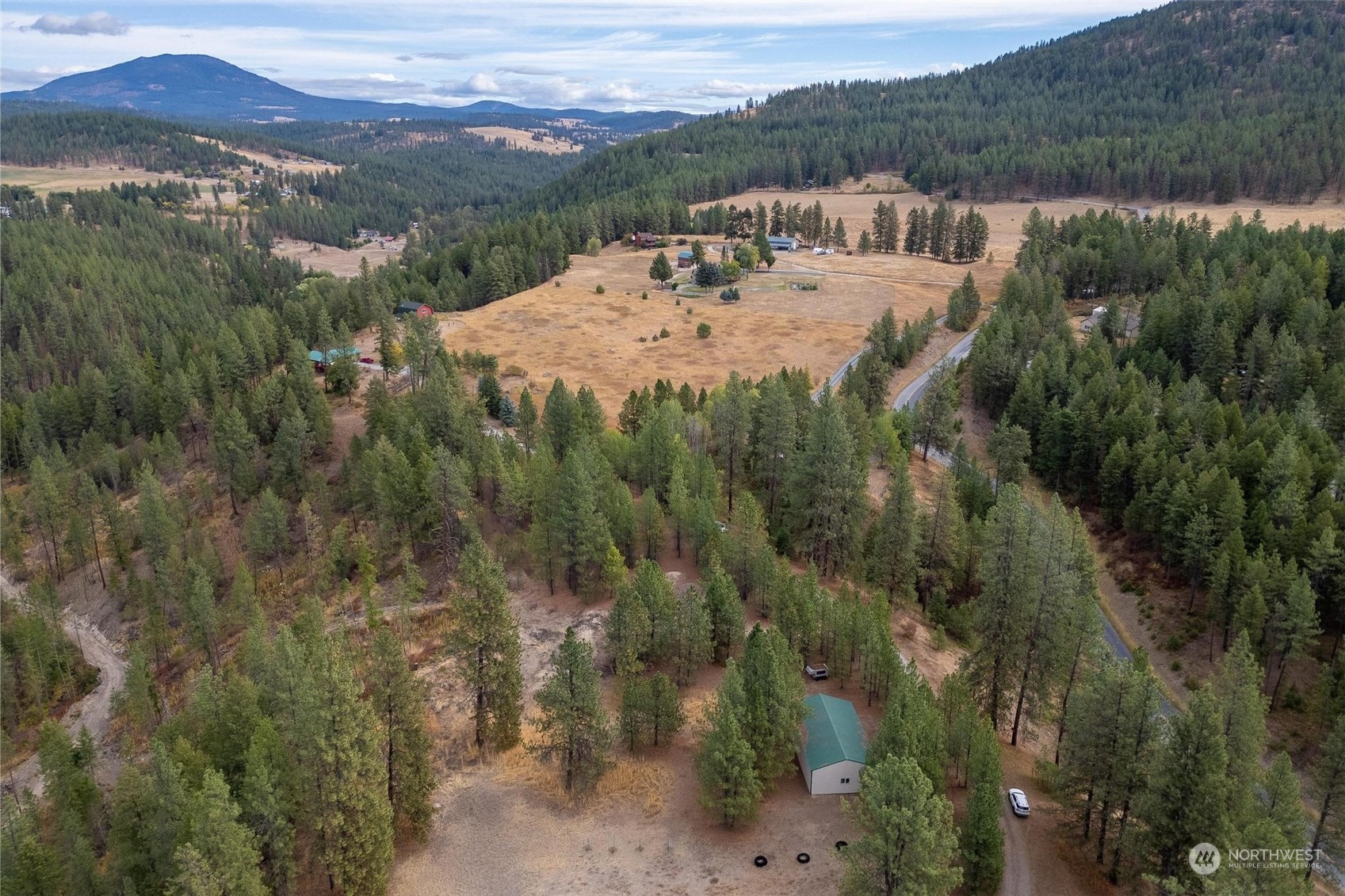 745 D Hall Road Colville, WA 99114 - Photo 1 of 27 a view of a lake with a mountain in the background