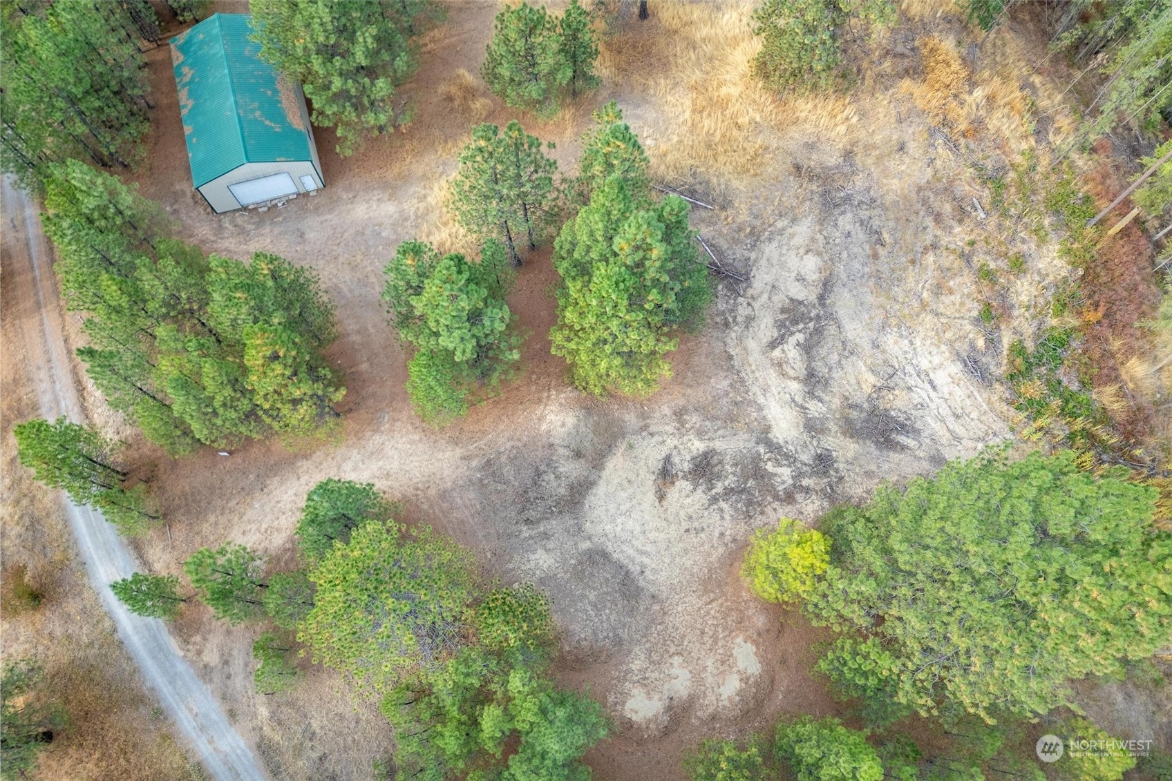 745 D Hall Road Colville, WA 99114 - Photo 4 of 27 an aerial view of a house with a yard and greenery