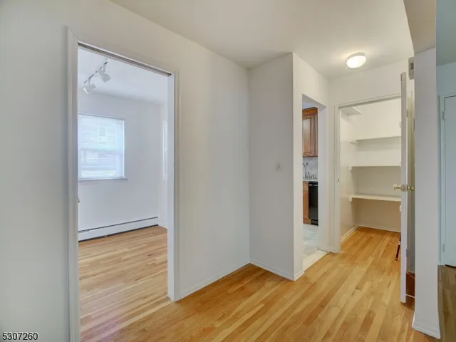 a view of hallway with wooden floor