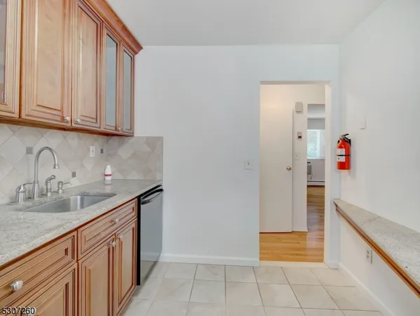 a kitchen with granite countertop a sink and a stove
