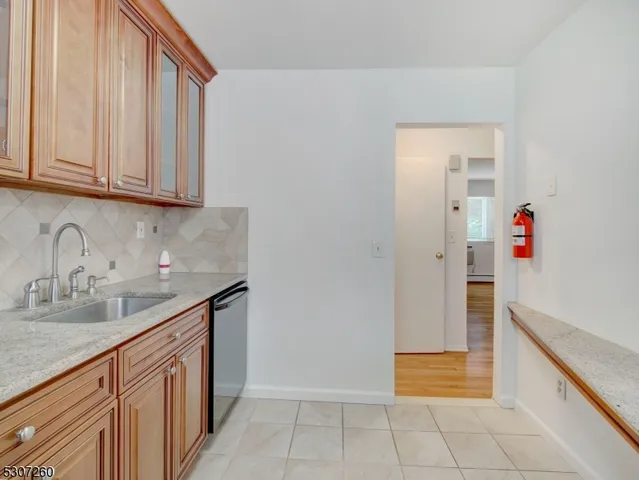a kitchen with granite countertop a sink and a stove