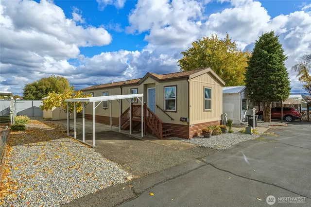 a view of a house with a patio and a yard
