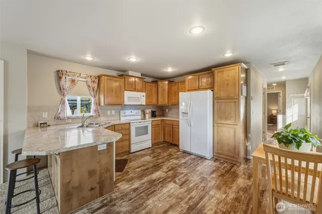 a kitchen with refrigerator cabinets and furniture