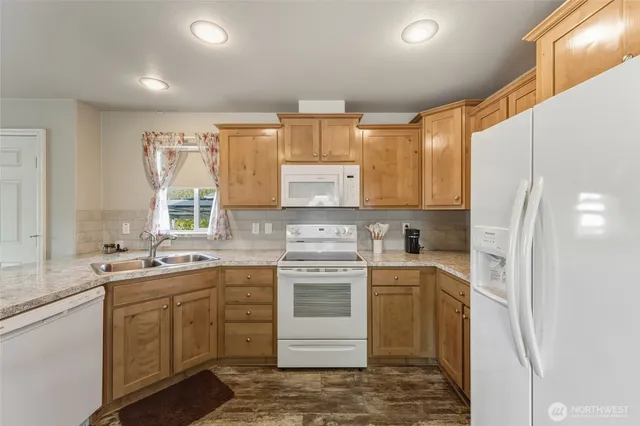 a kitchen with a sink stove and refrigerator