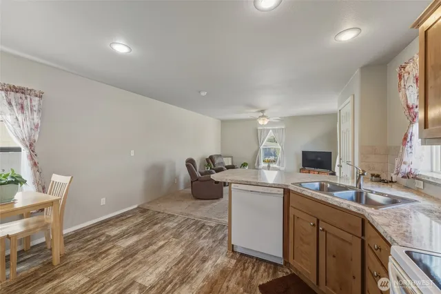 a kitchen with a sink appliances and cabinets