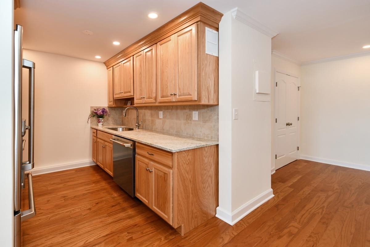 7000 Boulevard East, Unit 43H Guttenberg, NJ 07093 - Photo 2 of 8 a kitchen with a sink cabinets stainless steel appliances and a window
