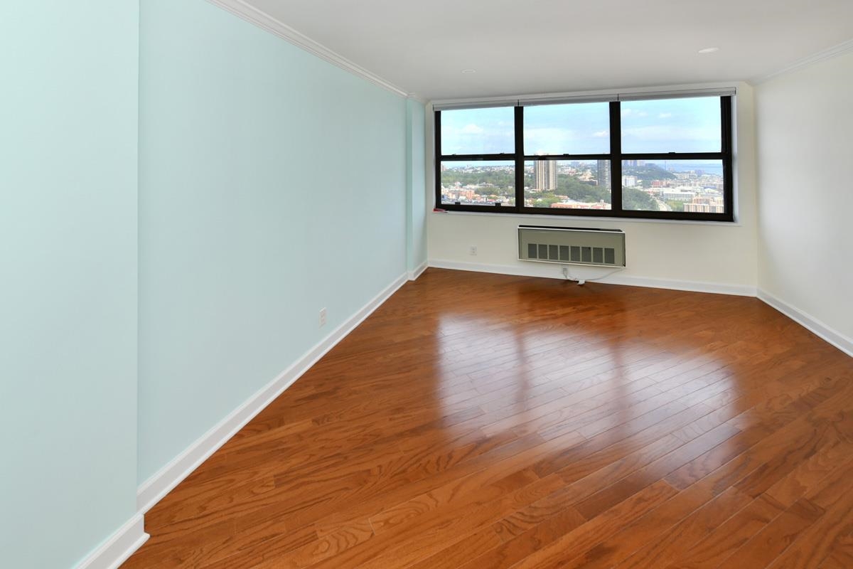7000 Boulevard East, Unit 43H Guttenberg, NJ 07093 - Photo 3 of 8 wooden floor in an empty room with a window