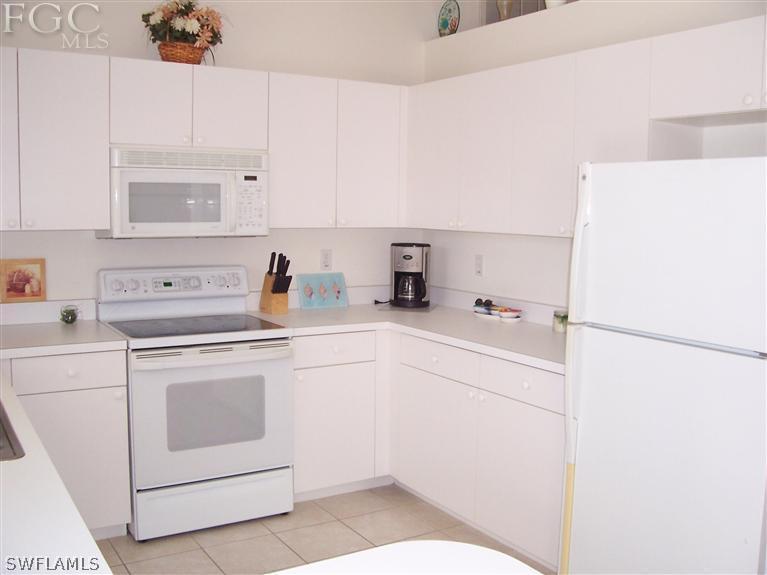 15669 Spring Line Lane Fort Myers, FL 33905 - Photo 13 of 13 a kitchen with a refrigerator sink and white cabinets