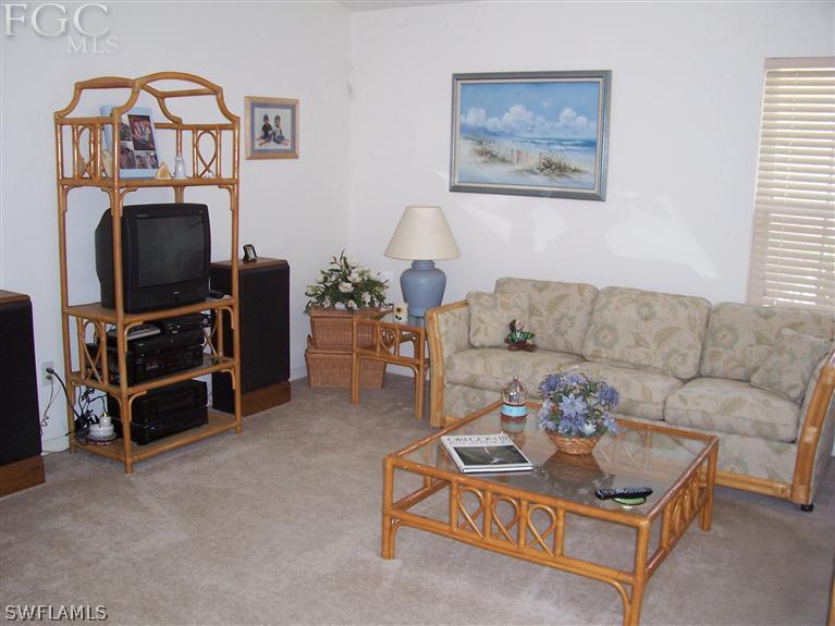 15669 Spring Line Lane Fort Myers, FL 33905 - Photo 6 of 13 a living room with furniture a flat screen tv and a window