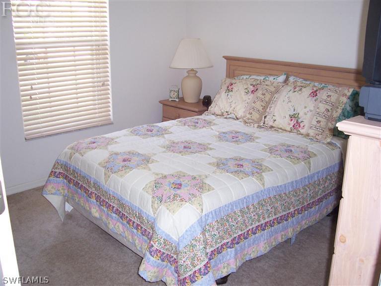 15669 Spring Line Lane Fort Myers, FL 33905 - Photo 7 of 13 a bedroom with a bed and a window