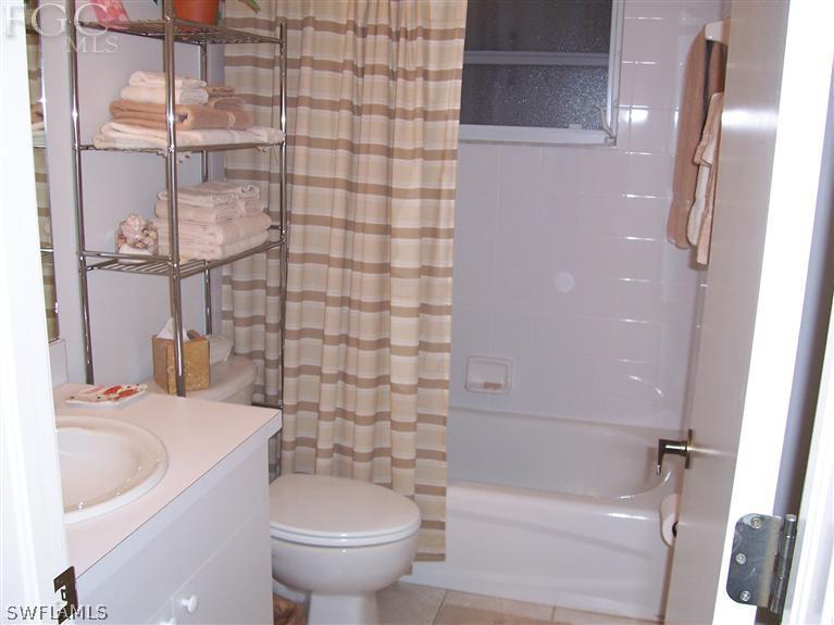 15669 Spring Line Lane Fort Myers, FL 33905 - Photo 8 of 13 a bathroom with a sink a toilet and shower