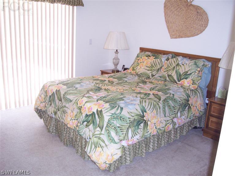 15669 Spring Line Lane Fort Myers, FL 33905 - Photo 9 of 13 a bed with a bed and a painting on the wall