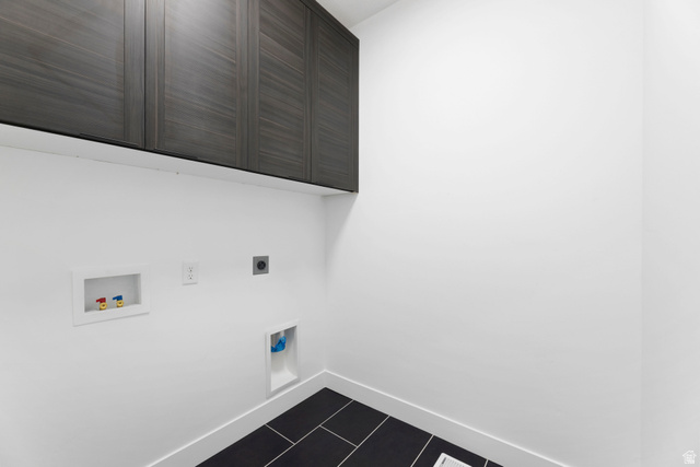14392 South Champ Cove Draper, UT 84020 - Photo 24 of 31 Laundry room with cabinet space, electric dryer hookup, washer hookup, and dark tile patterned flooring