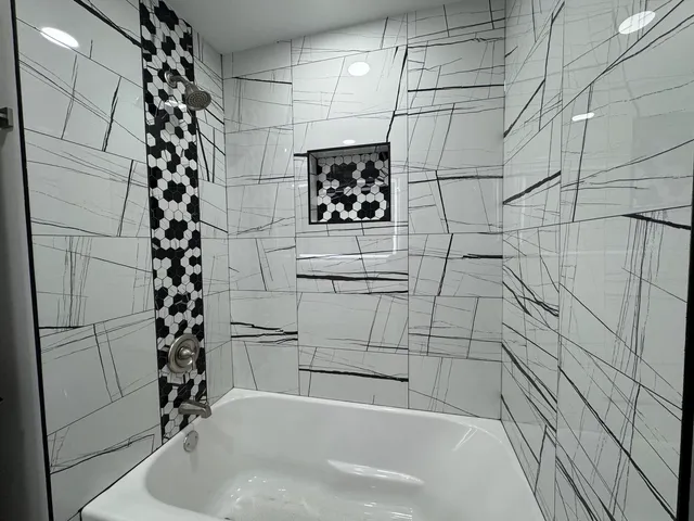 a bathroom with a bathtub and shower