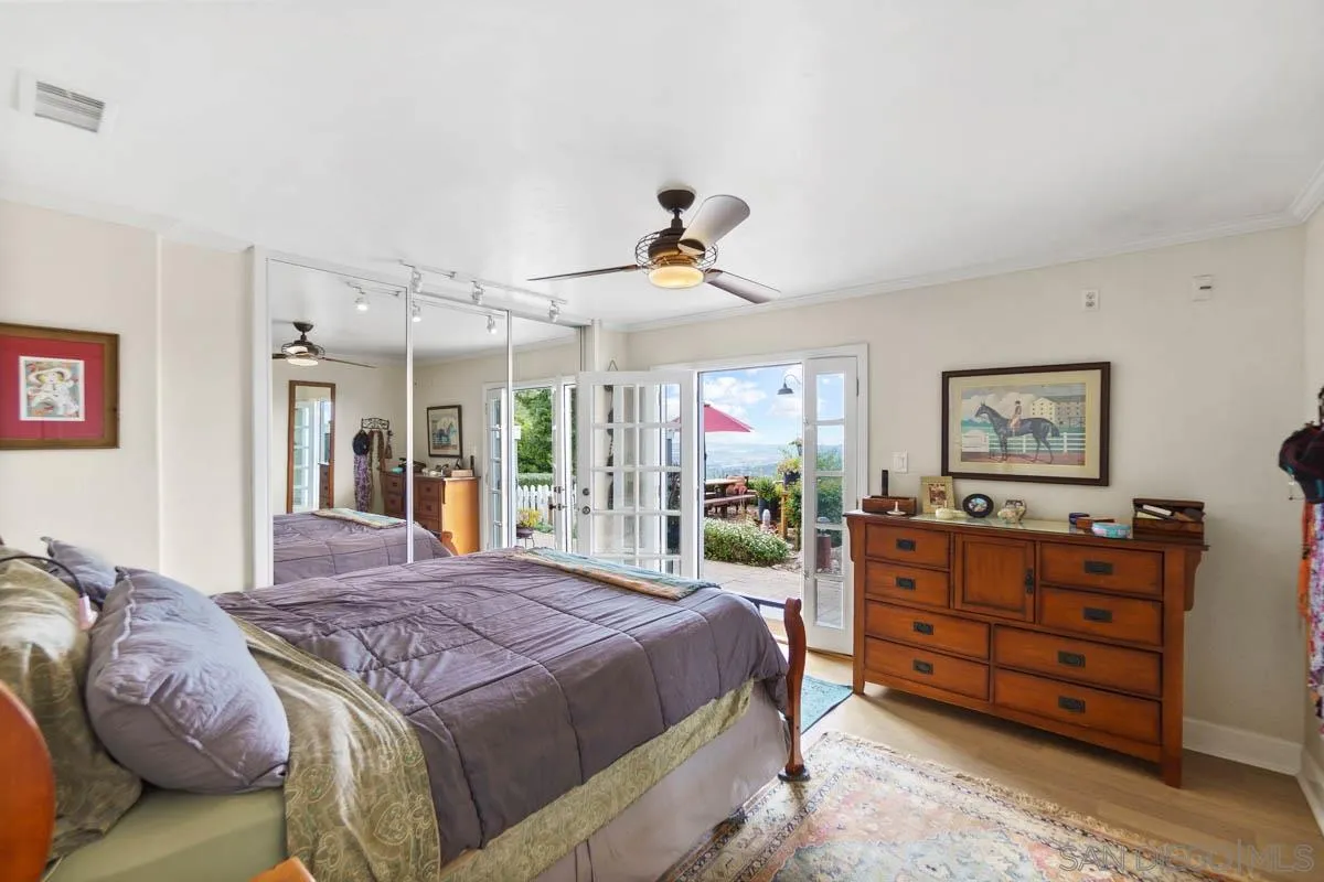 14770 High Valley Road Poway, CA 92064 - Photo 17 of 32 a bedroom with a bed and wooden floor