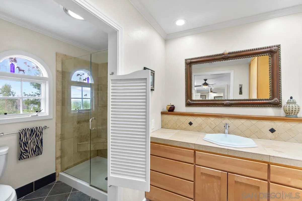 14770 High Valley Road Poway, CA 92064 - Photo 18 of 32 a bathroom with a sink mirror and vanity