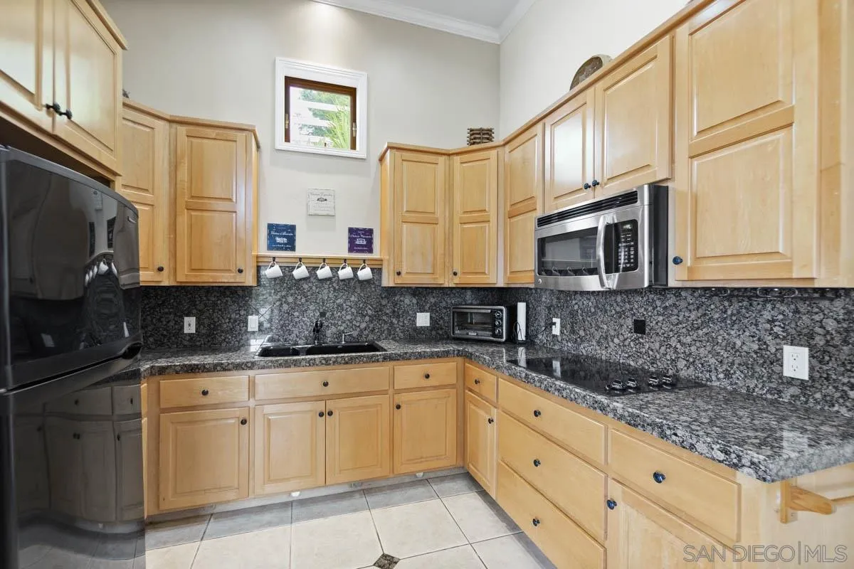 14770 High Valley Road Poway, CA 92064 - Photo 24 of 32 a kitchen with stainless steel appliances granite countertop a sink a stove and cabinets