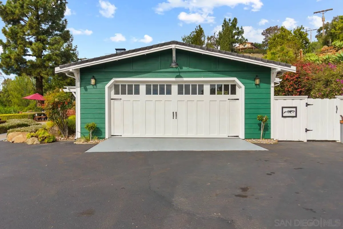 14770 High Valley Road Poway, CA 92064 - Photo 29 of 32 a front view of a house with a garden and garage