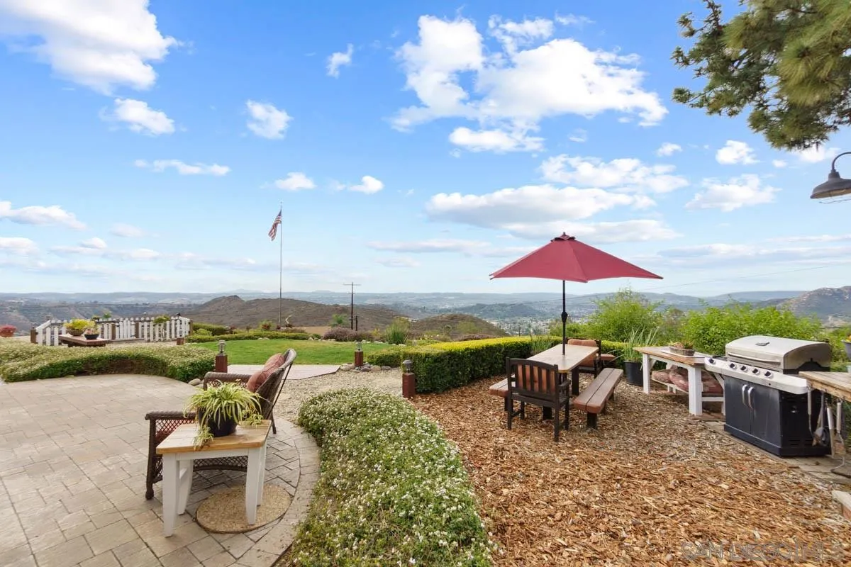 14770 High Valley Road Poway, CA 92064 - Photo 5 of 32 a view of a terrace with furniture and umbrella