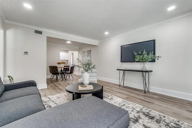 a living room with furniture and a painting on the wall