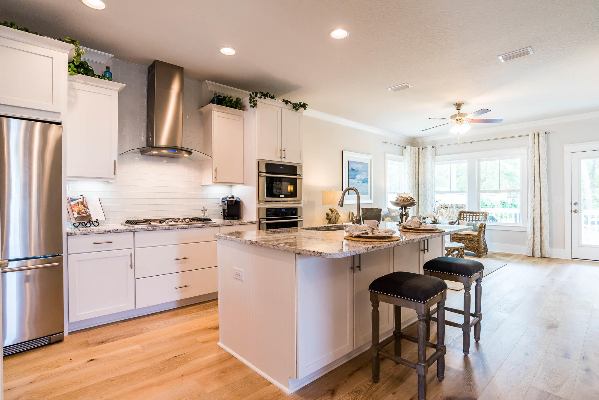 44 Grande Pointe Drive Inlet Beach, FL 32461 - Photo 39 of 54 a kitchen with a sink a stove a refrigerator and white cabinets with wooden floor