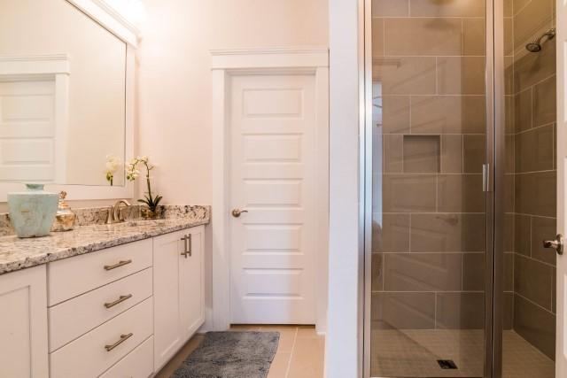 44 Grande Pointe Drive Inlet Beach, FL 32461 - Photo 45 of 54 a bathroom with a granite countertop sink a mirror and a shower