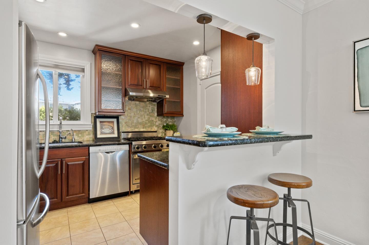 916 Linden Avenue Burlingame, CA 94010 - Photo 15 of 56 a kitchen with stainless steel appliances granite countertop a stove and a sink