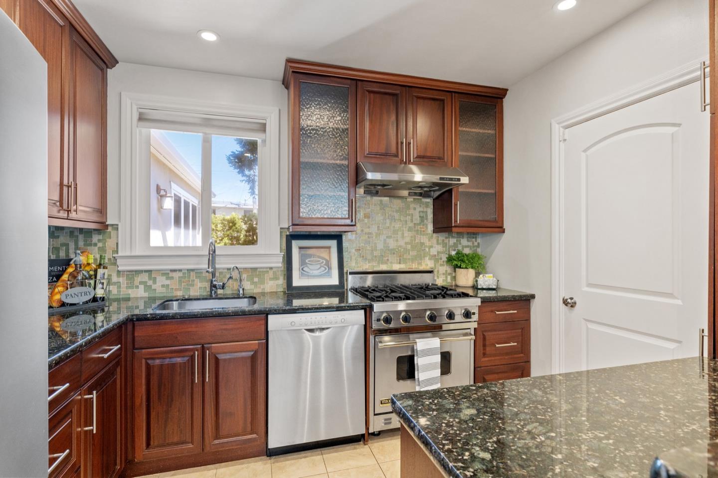 916 Linden Avenue Burlingame, CA 94010 - Photo 16 of 56 a kitchen with stainless steel appliances a sink stove and cabinets