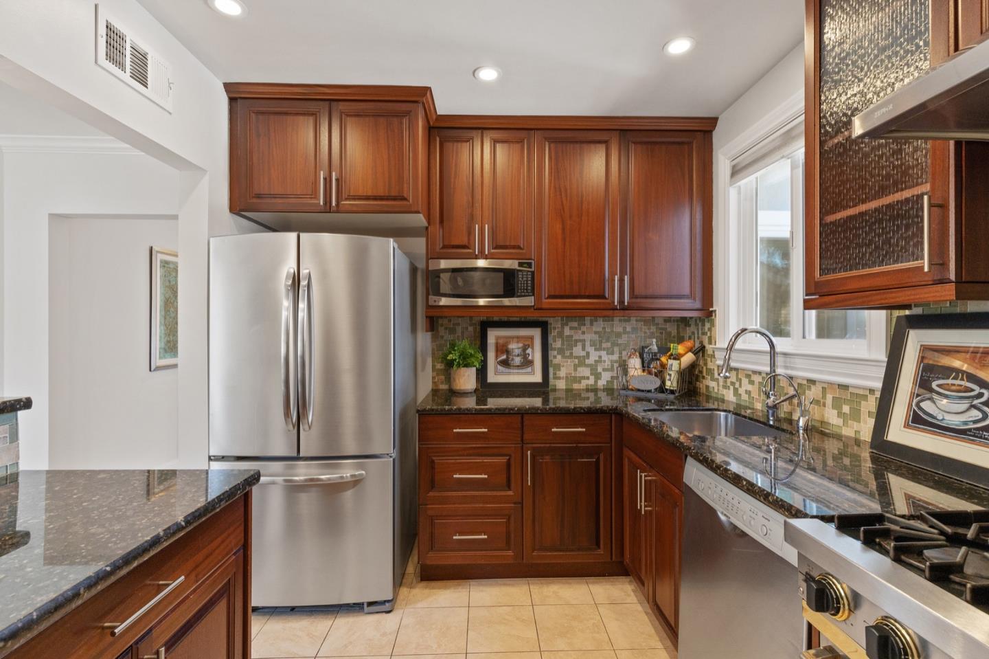 916 Linden Avenue Burlingame, CA 94010 - Photo 17 of 56 a kitchen with stainless steel appliances granite countertop a refrigerator sink and stove
