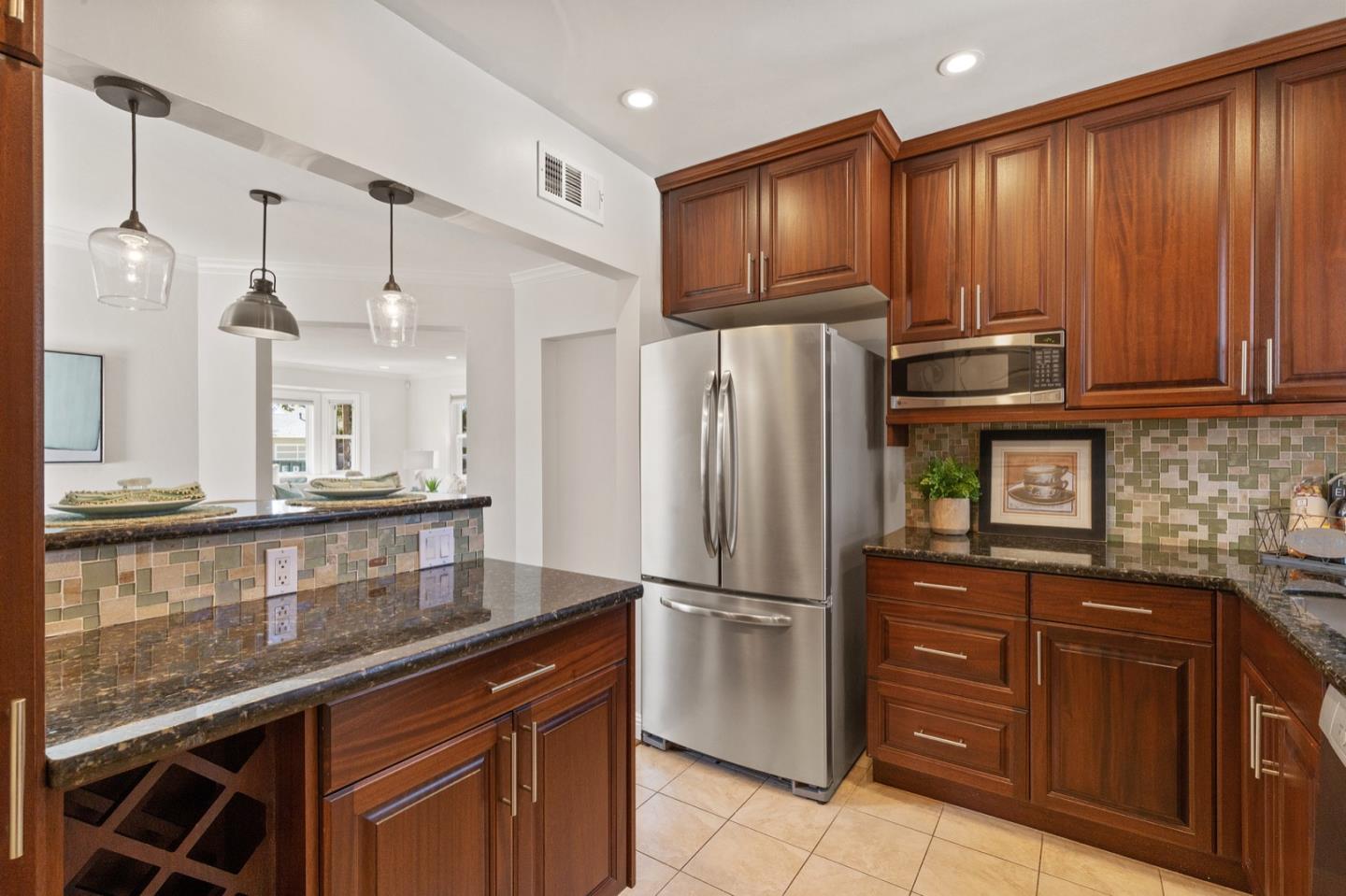 916 Linden Avenue Burlingame, CA 94010 - Photo 18 of 56 a kitchen with stainless steel appliances granite countertop a refrigerator and a sink