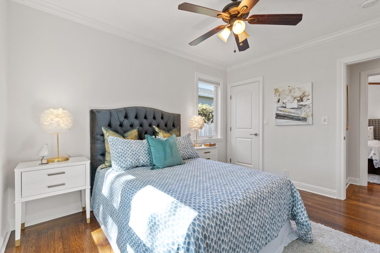 916 Linden Avenue Burlingame, CA 94010 - Photo 20 of 56 a bedroom with a bed and wooden floor