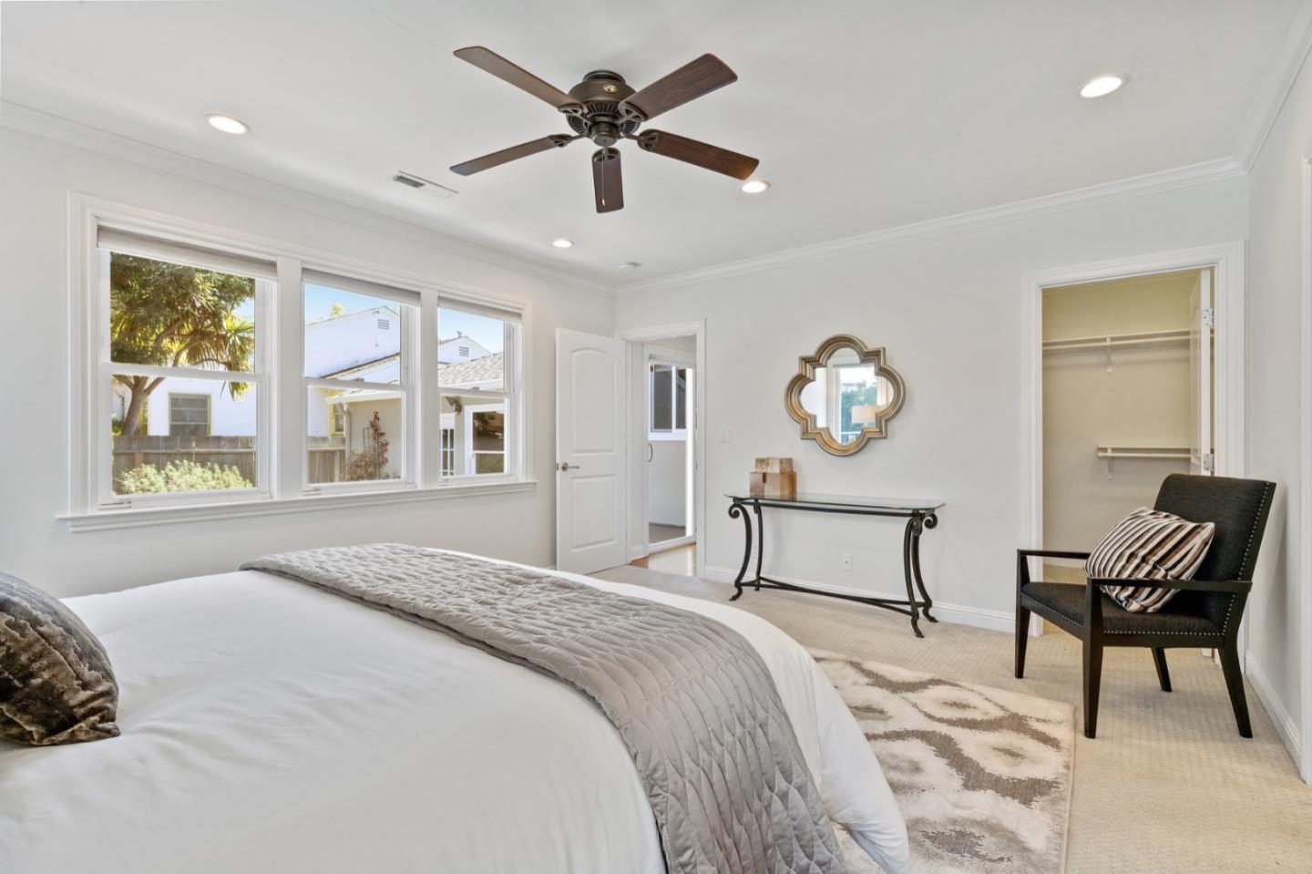 916 Linden Avenue Burlingame, CA 94010 - Photo 28 of 56 a bedroom with a bed a window and a chandelier