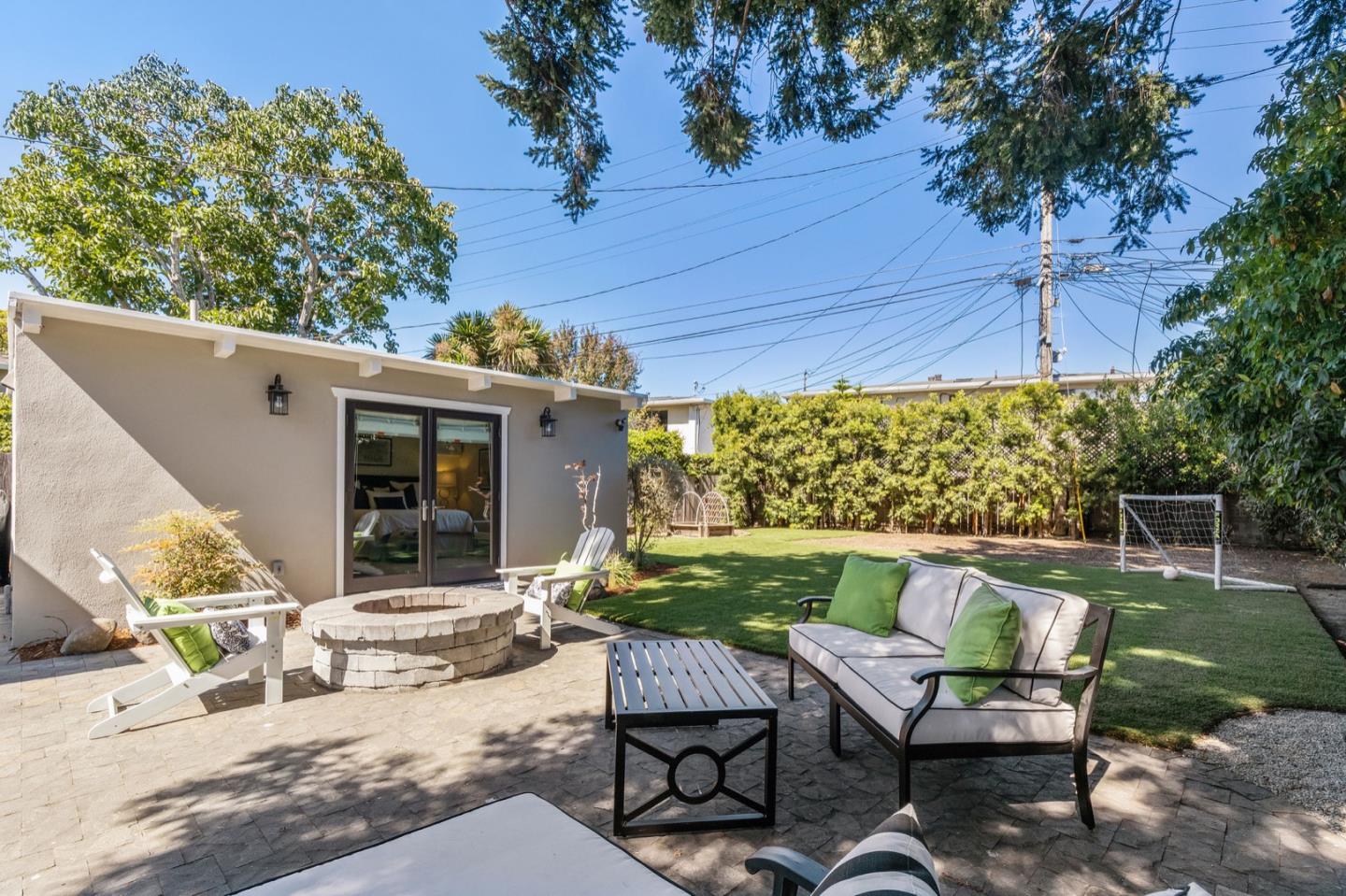 916 Linden Avenue Burlingame, CA 94010 - Photo 38 of 56 a view of a patio with a table chairs and a backyard